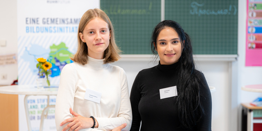 Zwei Student*innen im Klassenraum vor einer Tafel